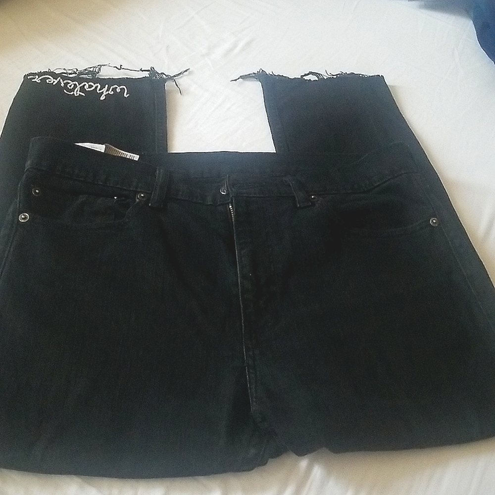 Levi's black jeans.  The word "whatever" embroidered on the bottom of the leg.